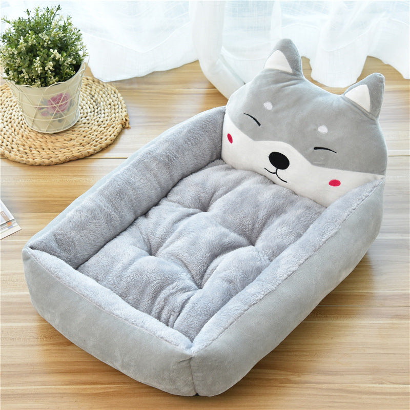Soft grey fleece pet bed with cushioned edges and playful animal face pillow for cozy comfort
