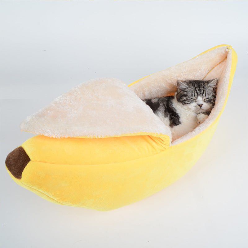 Cozy plush pet bed shaped like a banana with soft removable washable lining and a sleeping cat inside