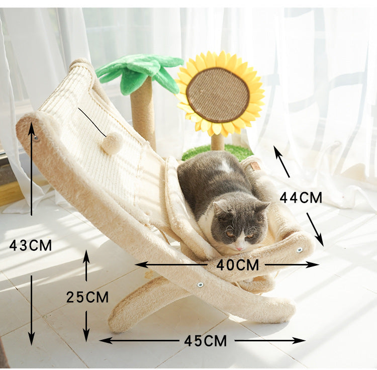 Plush beige cat sofa bed with cushioned lounge and attached play pompom in bright sunny room
