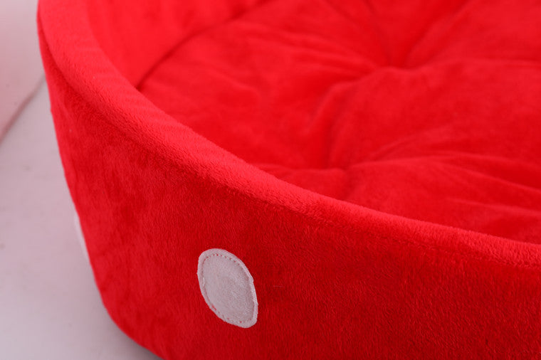 Close-up of a plush red pet bed mattress with soft texture and cozy, durable design for cats and dogs