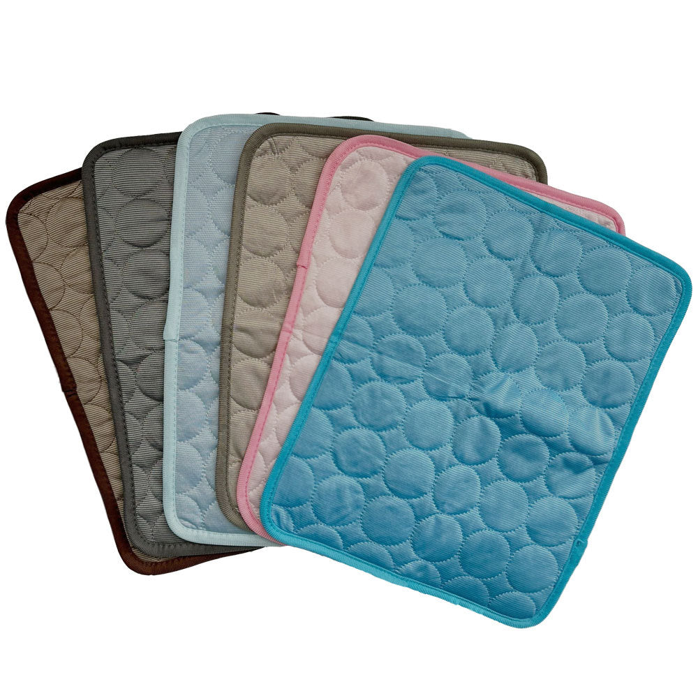 Set of plush cooling pet mats in various muted colors with quilted dot texture and trim edges