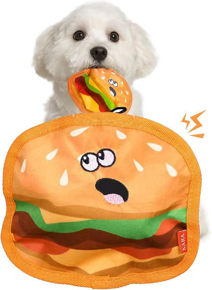 Small white dog holding a durable orange chew toy shaped like a playful hamburger with textured fabric