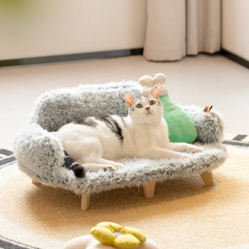 Cat lounging on a cozy elevated wooden pet sofa bed with soft plush fabric and modern design