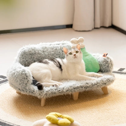 Cat lounging on a cozy elevated wooden pet sofa bed with soft plush fabric and modern design