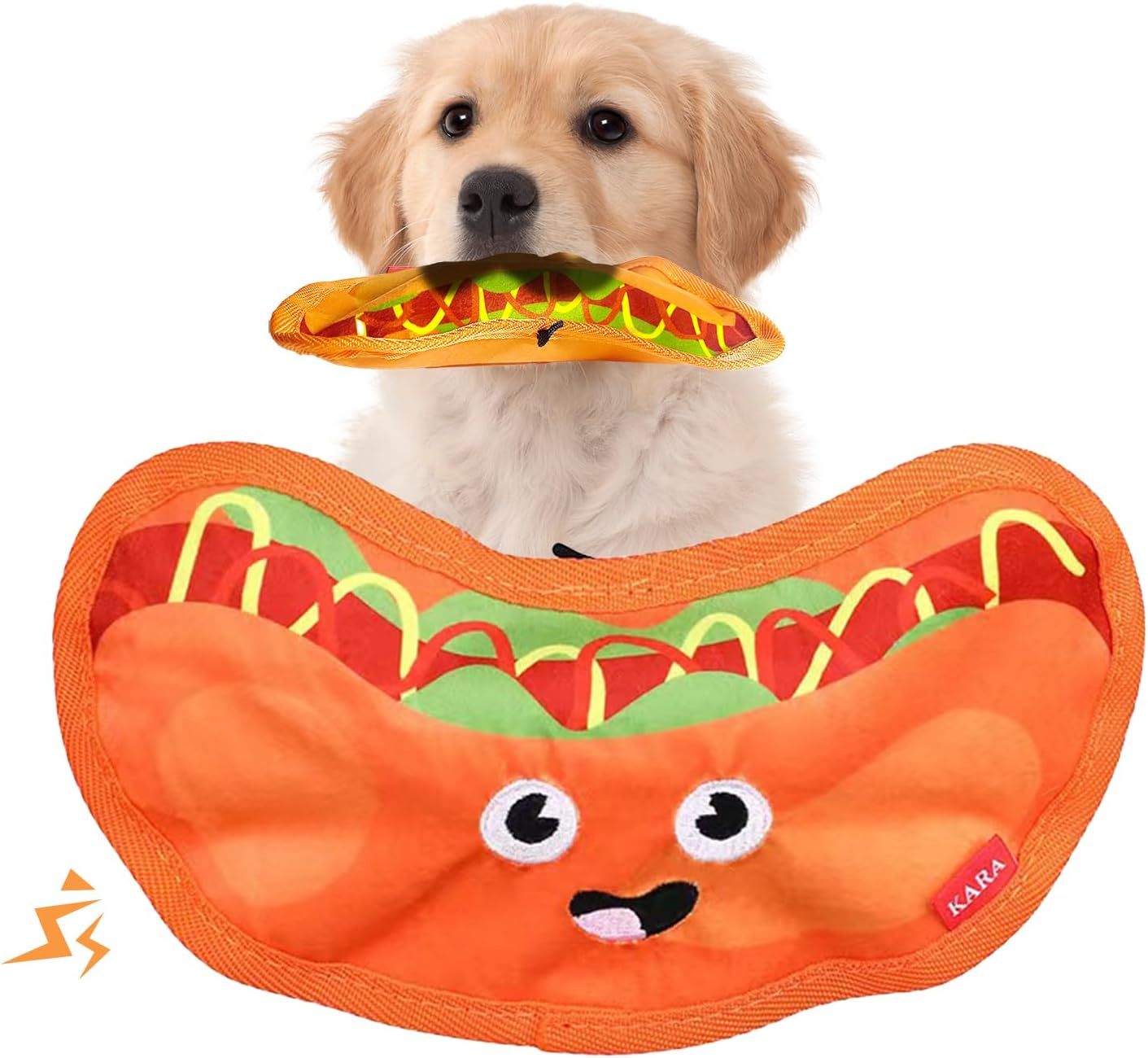 Golden retriever puppy holding an orange plush dog toy resembling a smiling hot dog with crinkle texture