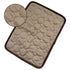 Beige textured cooling pet mat with circular quilted pattern and dark brown trim edges