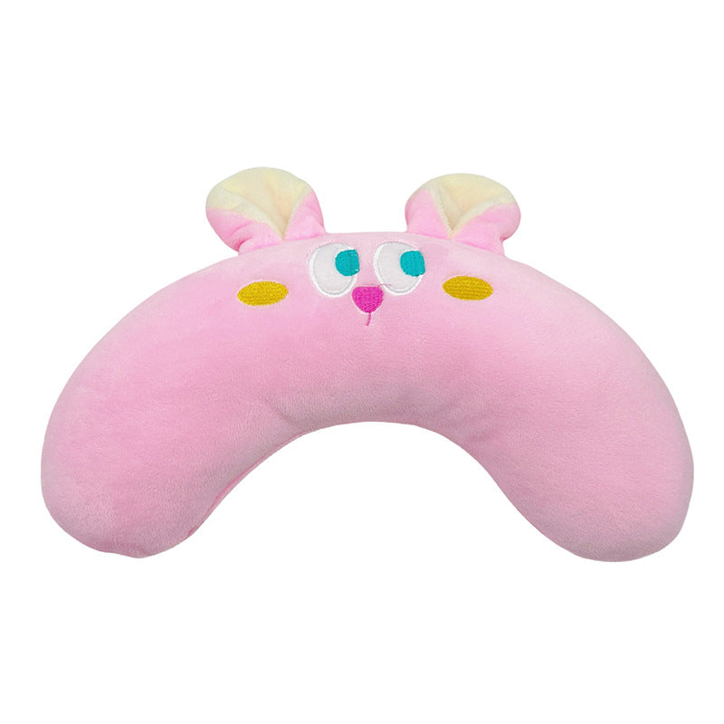 Pink crescent-shaped cat pillow with embroidered face and soft plush material for cozy comfort