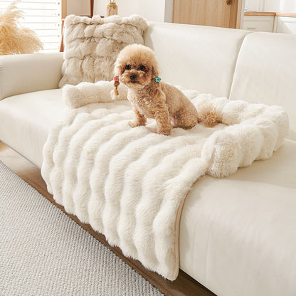 Small dog sitting on a plush, thickened cream-colored thermal pet mat on a modern sofa
