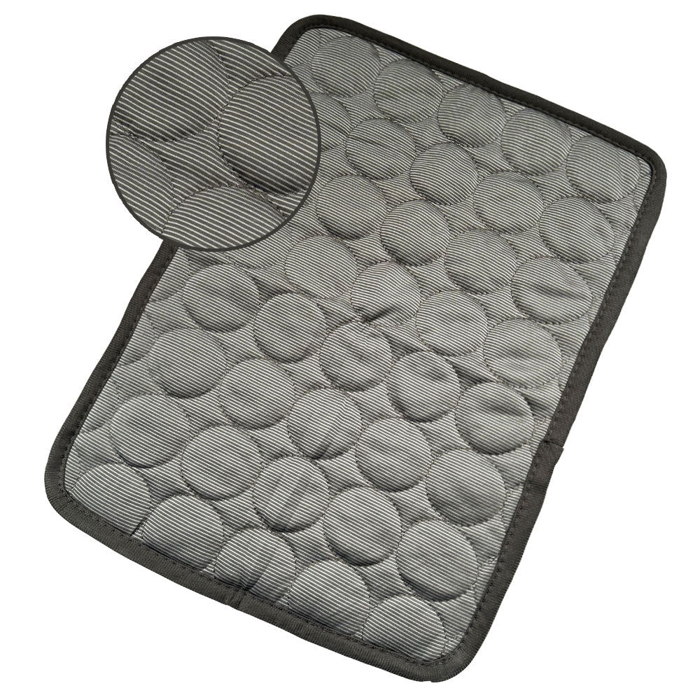 Gray textured cooling pet mat with quilted circular padding and dark trim for indoor use