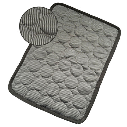 Gray textured cooling pet mat with quilted circular padding and dark trim for indoor use
