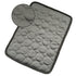 Gray textured cooling pet mat with quilted circular padding and dark trim for indoor use